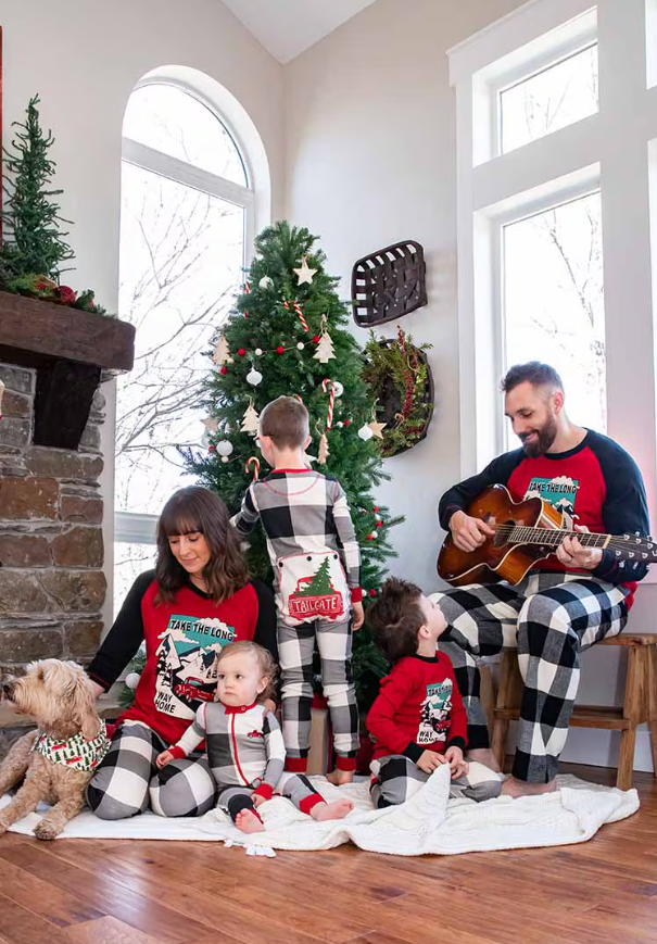 family wearing matching black and white buffalo plaid pajamas for a Christmas card photo