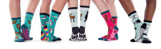 four people wearing different patterns of LazyOne socks