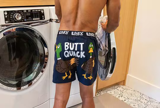 man standing in laundry room wearing butt quack duck themed boxers