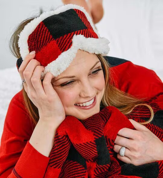 woman laying down wearing a plaid sleeping mask