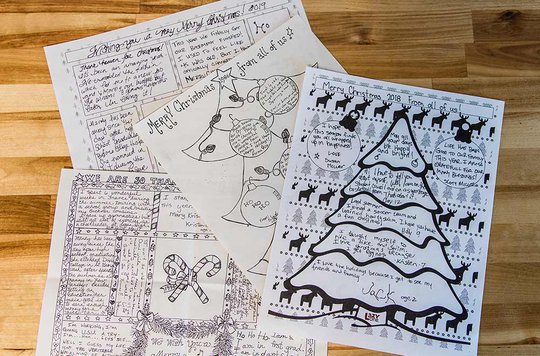 four pieces of paper with Christmas-themed designs printed and handwritten notes filling open spaces
